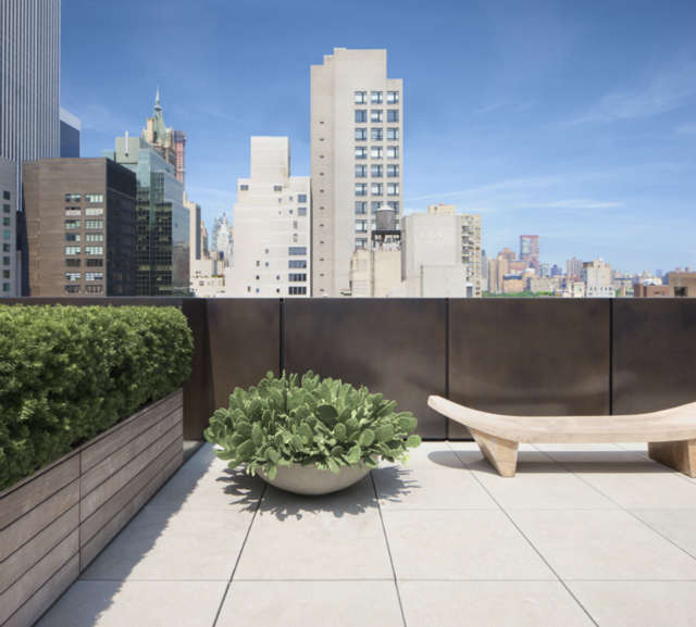  Park Avenue Roofscape: PARK AVENUE ROOFSCAPEJCA&#8\2\17;s design for this previously unfinished \2,800 s.f. roof creates a private oasis by concealing existing elements that create visual chaos and simplifying sight lines to bring the skyline view to the forefront. Machine room walls are screened with resin panels. Bent sheets of bronze conceal the parapet from view. An aluminum and wood shade canopy cantilevers off the building&#8\2\17;s side. And the greenery in wood cladded planters softens the rigid geometry of the space,