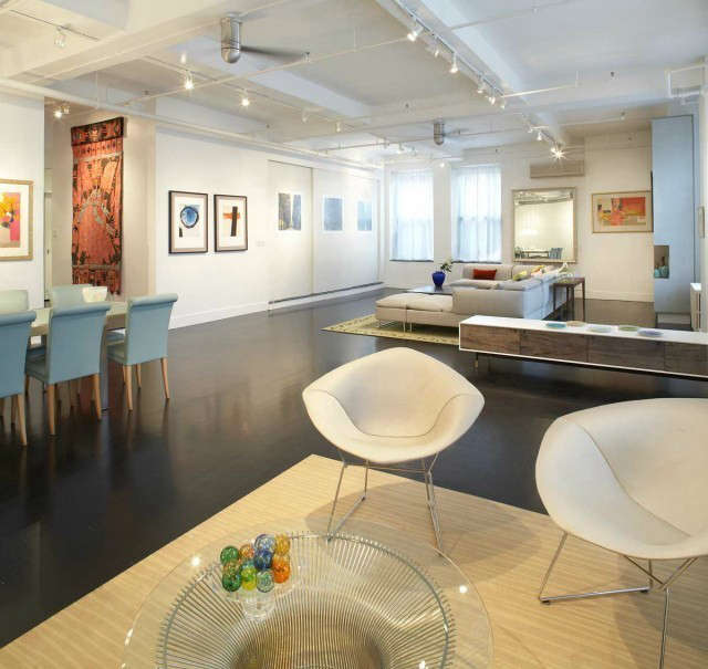  Soho Loft: On SoHo&#8\2\17;s East side, we reorganized existing spaces to best accommodate our client&#8\2\17;s desire to host social gatherings while retaining an intimate living environment. New furniture and lighting complement this loft&#8\2\17;s contemporary design while collectibles add life and splashes of color. Art is prominently displayed on multiple surfaces using a variety of materials and textures. A suspended wood panelled set of doors discreetly hides a large storage closet. Photo: Ty Cole.