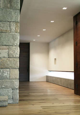  entry hall: a low concrete wall with frameless glass provides views to the garden with ample wall space for artwork