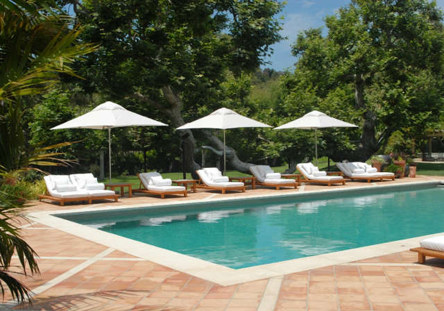  Malibu Estate: Pool viewDesigned to feel like a splendid tropical resort hotel, the tile-lined pool beckons with Italian-designed teak lounge chairs. Photo: Russ Cletta