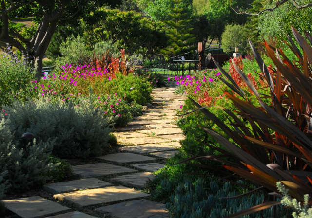  Malibu Residence: Stone footpathNatural stepping stones meander through brilliant blooms and drought-resistant perennials. Photo: Russ Cletta
