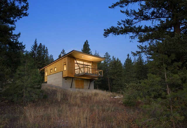  Pine Forest Cabin: In order to meet the client’s budget goals, an efficient plan and cost effective selection of building materials reduced construction costs and led to the simple design. The use of sheet materials both inside and out maximized material efficiency while emphasizing the simplicity of the cabin’s form. Elevating the cabin allowed for unobstructed views down slope and to the mountains beyond, transforming a modest living space from ordinary room to a viewing platform that extends from inside to out. Photo: Steve Keating Photography