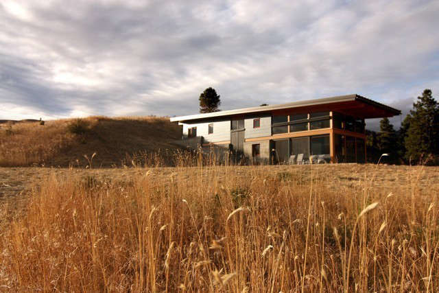  Nahahum Canyon: Located north of Cashmere, Washington, in the Nahahum Canyon, this \1500 square foot two story dwelling is set into the hillside with concrete retaining walls that guide the form of the cabin. Its east west longitudinal axis and generous overhangs are designed to take advantage of solar orientation while maintaining panoramic views. Photo: Balance Associates Architects