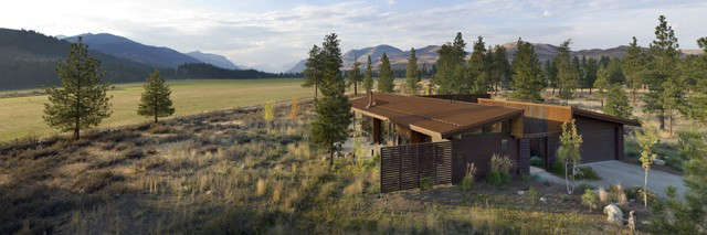  Wolf Creek Residence: The Wolf Creek Residence sits in a lightly treed meadow, surrounded by foothills and mountains in Eastern Washington. The home is designed as two interlocking “L’s”. A covered patio is located at the intersection of one “L,” offering a protected place to sit while enjoying sweeping views of the valley. A lighter screening “L” creates a courtyard that provides shelter from seasonal winds and an intimate space with privacy from neighboring houses. Photo: Steve Keating Photography