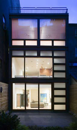  West Village Glow*: West Village Glow*&#8\2\1\1; After the removal of a ramshackle greenhouse appendage at the rear of this townhouse, a new facade of exposed structural steel and large custom wood windows brought light and warmth into the kitchen and family room that face the rear garden. The owner wanted a design that was complimentary to their collection of mid century modern furniture, lighting and decorative objects.