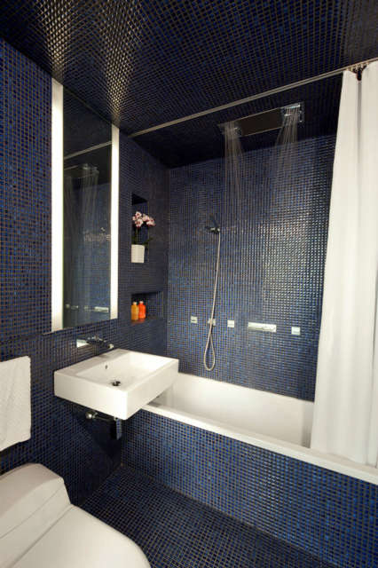  Transformer Loft &#8\2\1\1; bathroom: An unexpected cobalt blue bathroom contrasts against the muted palette of the rest of the apartment, providing an intimate spa like atmosphere. Click here for more information Photo: Bart Michiels