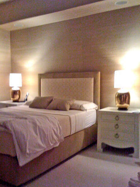  South Beach, Miami, FL: This apartment is on the \29th floor of a building at the very south tip of South Beach. Spectacular views of Miami Beach and the Atlantic Ocean were a lot to compete with, so we opted for quiet luxury as a foil for the expanses of glass. In the master bedroom, we covered the walls in silk and designed a bed upholstered in linen. White lacquered nightstands are a nod to mid-century Miami style. The entry has walls sheathed in pale green frosted mirrors: our take on beach glass.