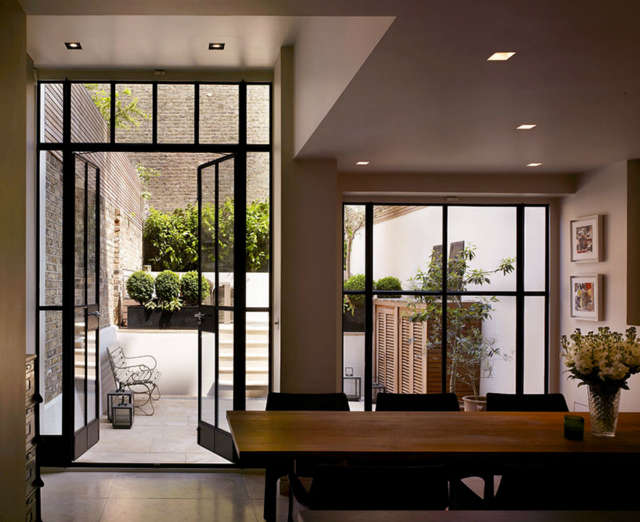  Notting Hill House (3): The narrow facade of this West London house hides an interior of rich volumes. Reconstructed behind a retained facade, the new generous floor to ceiling heights along with the introduction of sliding walls and glazed screens create a light and spacious family home. Photo: Kilian O&#8\2\17;Sullivan