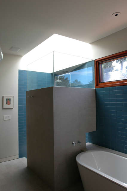  Winebaum Shower and Bath &#8\2\1\1; A blue tiled bathroom with natural light from the skylight over the shower. Clerestory windows permit more natural light and provide a well lit bathroom.