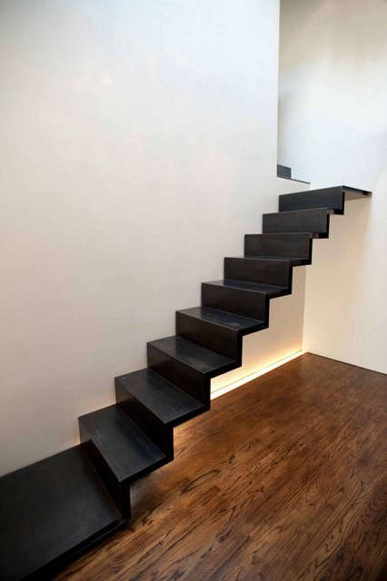  Loft Stair: Connected to walls only at its ends, this blackened-steel stair floats from the wall. A water-jet cut system of structure is concealed in the thickness of the stair to pull off this impossible-looking feat.