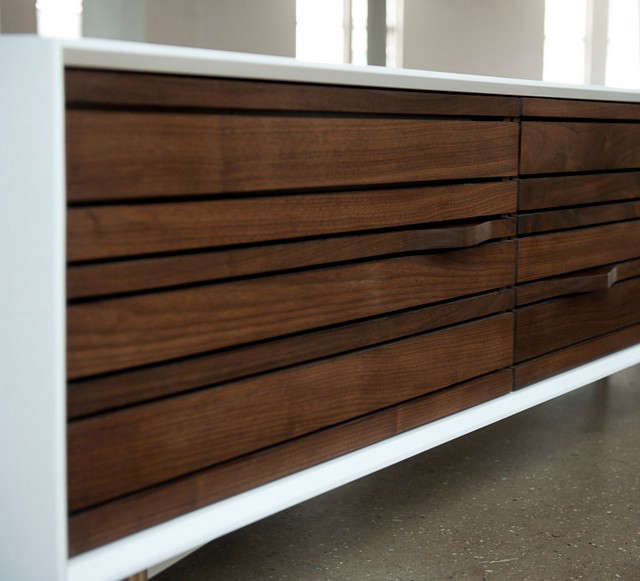  Media Credenza: Hand-oiled walnut has been carved to create handles for this media storage piece.
