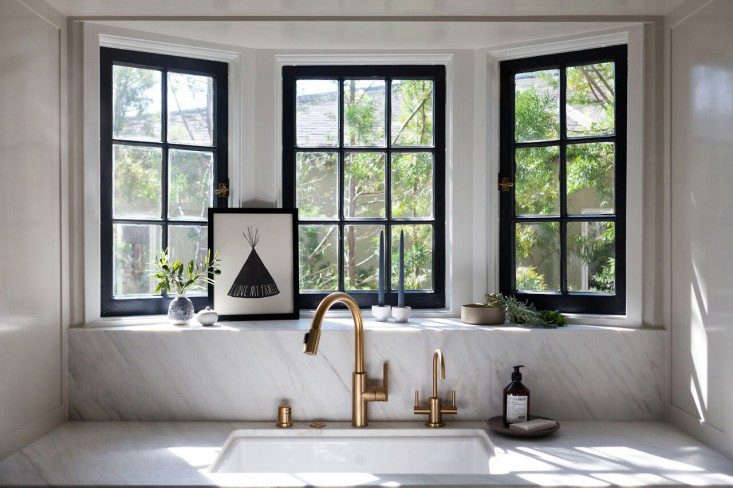 Calacatta marble frames the sink and windows in interior designer Amy Sklar’s LA kitchen. See the rest at Kitchen of the Week: Practicality in White Marble.
