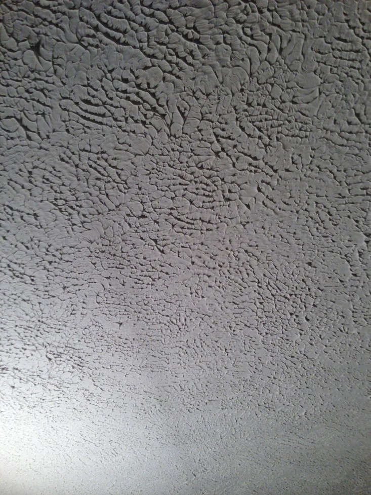 The type of texture you might want to get rid of: unsightly ridges, shown here on a ceiling (which the homeowners covered up with beadboard). See their solution at Rehab Diaries: DIY Beadboard Ceilings, Before and After.