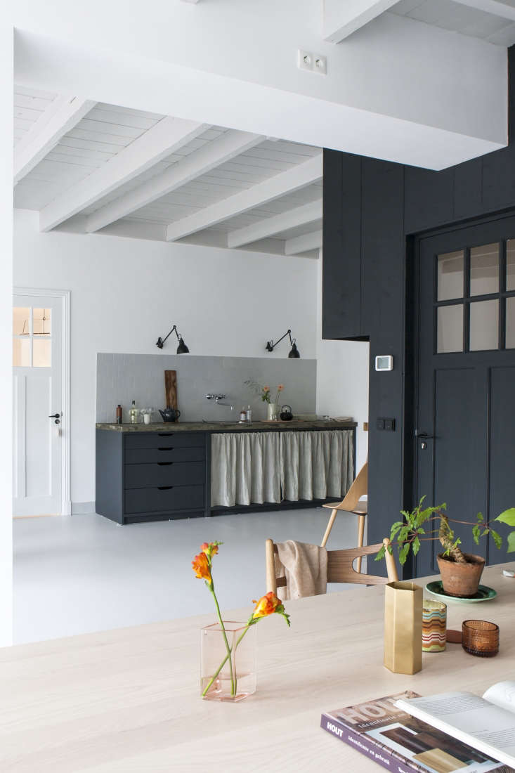 Christen-Starkenburg Interieur-Plus workspace/curtained kitchen at Jan de Jong, a design shop in Friesland, the Netherlands | Remodelista