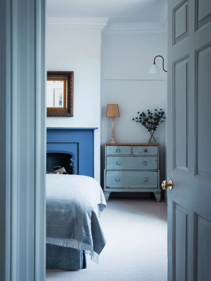 Bedroom with Blue Fireplace in Blue Dorset House by Mark Lewis, Photo by Rory Gardiner