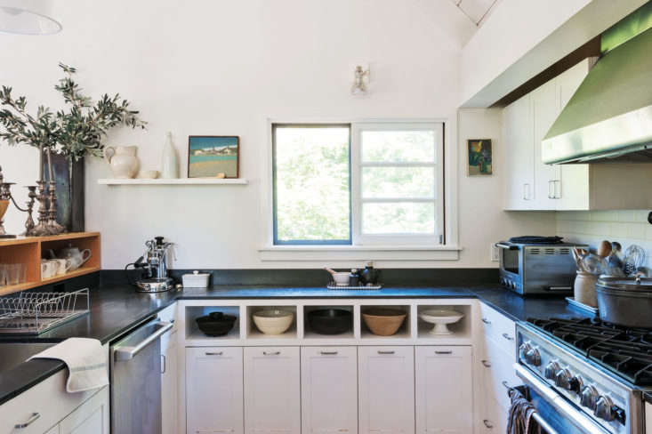 Julie’s horseshoe kitchen in Mill Valley, California, is small but efficient. “Dinnertime drop-ins are a frequent occurrence, and I love to cook, so it was important to me that the kitchen be outfitted for action,” she says. Her architect, Jerome Buttrick, provided well-designed storage that allows for all of the necessities to be kept on hand but out of sight. Inset open-shelving creates an eye-catching mixing bowl display. For a full tour and dissection of the kitchen, see the Remodelista book. Photograph by Matthew Williams for Remodelista.
