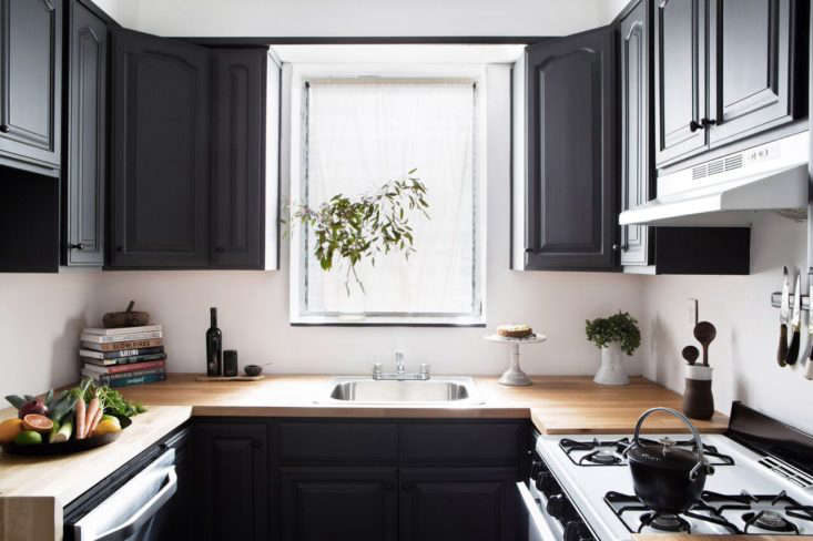 Designer Athena Claderone tackled her compact kitchen in Brooklyn with dark paint, Ikea countertops, and budget appliances. See more in Kitchen of the Week: A Low-Cost Before/After Kitchen in Brooklyn.