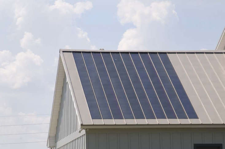 The photovoltaic panels in this building have been integrated into the standing-seam metal roof. Photograph via Fabral.
