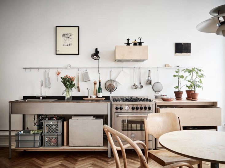 A freestanding range sits between freestanding counter units in Steal This Look: Smart Storage in a Swedish Kitchen.