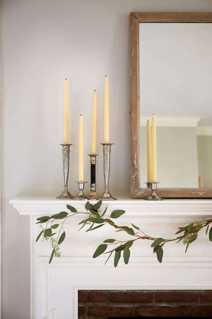 From there it was easy to style the rest of the mantel piece. The mirror, which weighs about 500 pounds and therefore never moves, maintained its position as the centerpiece. Complementing the silvery eucalyptus leaves, a grouping of sterling candlesticks with beeswax candles served as my requisite &#8\2\20;vertical element,&#8\2\2\1; while also adding a bit of holiday bling.