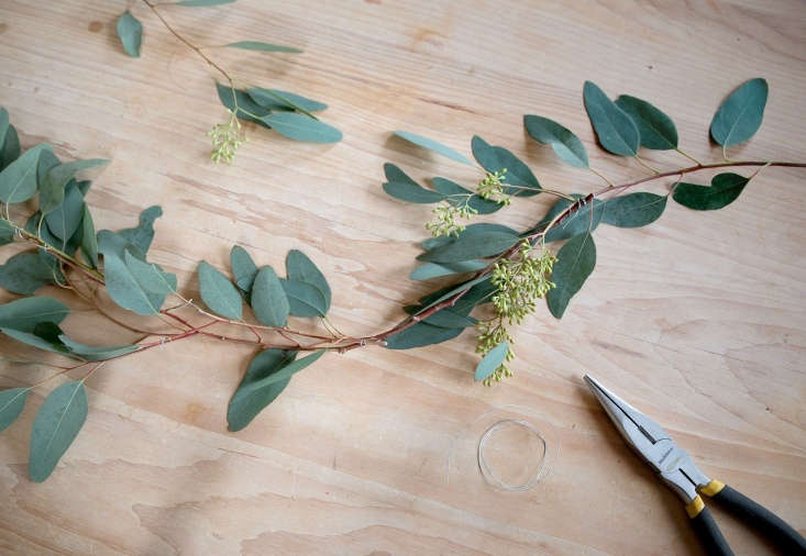 I have to admit, I picked up the \$5 seeded eucalyptus branches from my local Whole Foods with the idea of incorporating them into a more lush display, but my minimalist tendencies won out. Holding up one branch, I noted its graceful curving bow and thought, &#8\2\20;This would make a lovely garland.&#8\2\2\1; It was simple enough. First, I stripped excess branches to make one long stem. Overlapping the ends slightly, I then lashed about five branches together with floral wire. Finally, I secured the lightweight garland to my mantel with—yes—clear packing tape. Total time: \10 minutes.