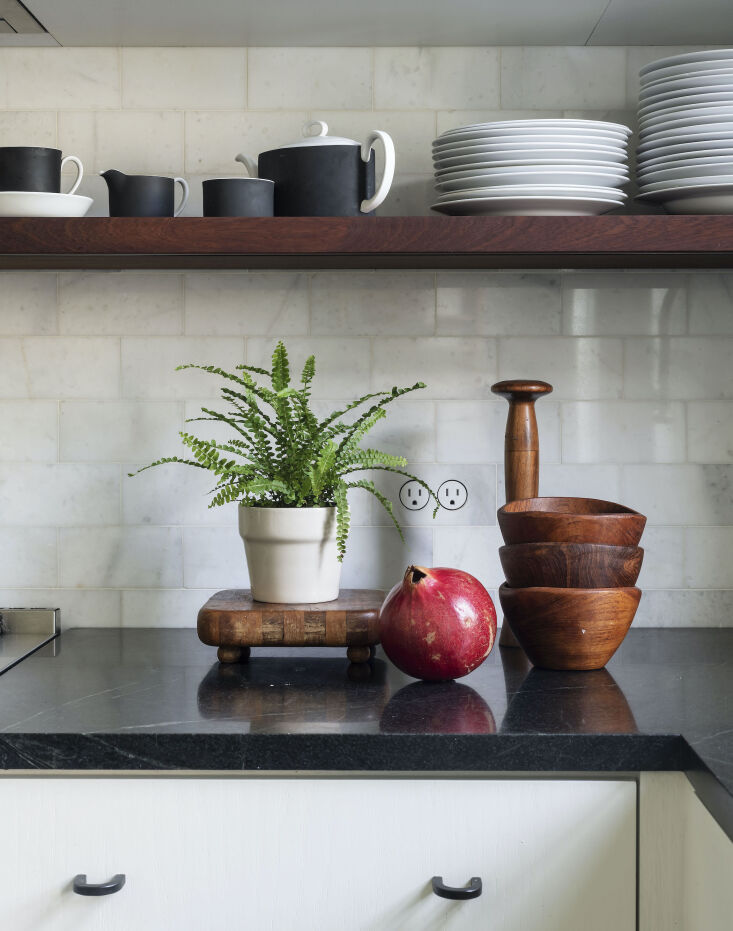Current Obsessions Upcycled Finds Black soapstone counter and vintage wood table accessories in architect Elizabeth Roberts Brooklyn kitchen update