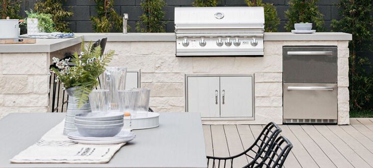  Above: A grill, under-counter fridge, and plenty of counter space makes an efficient outdoor kitchen.