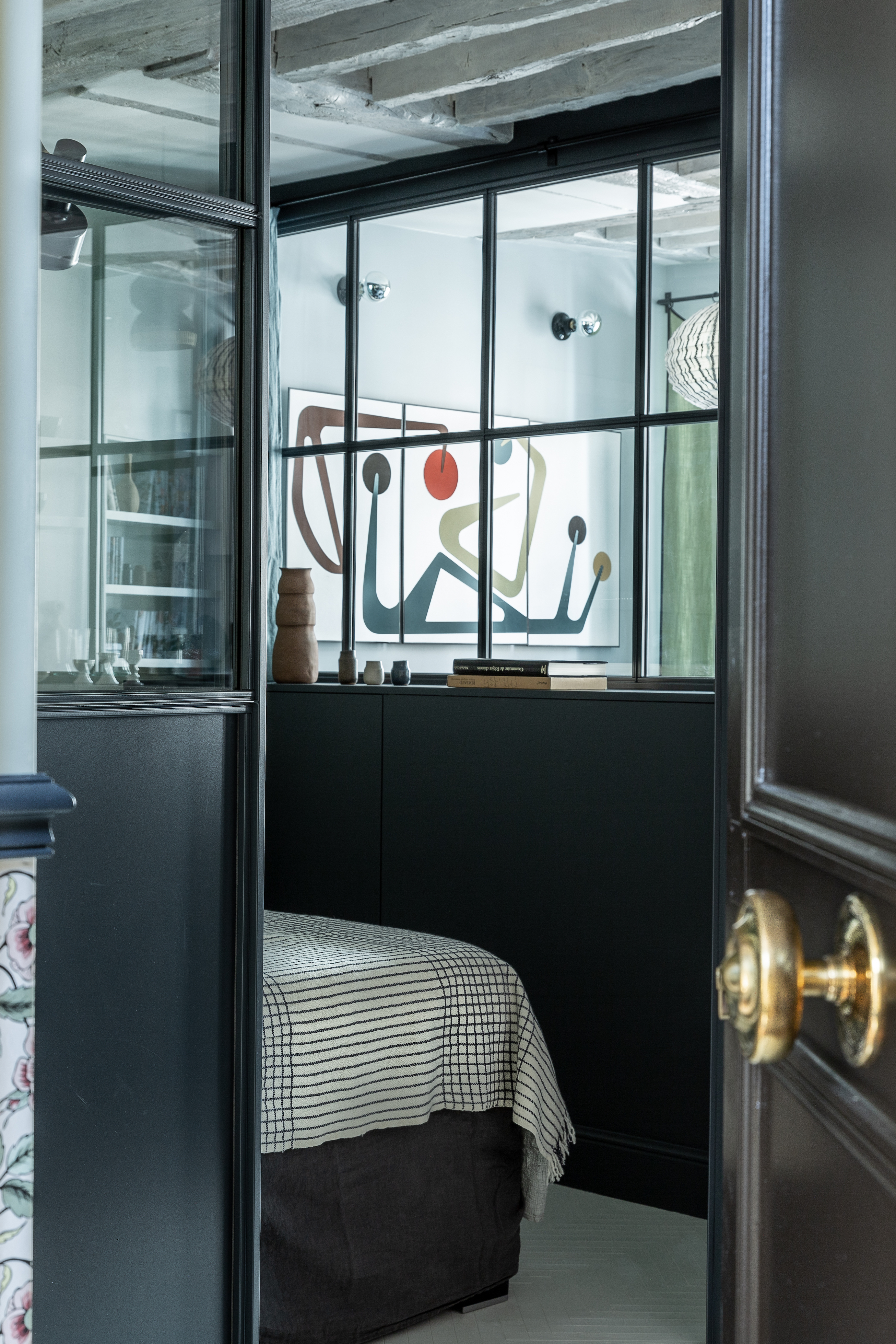 Bedroom enclosed by interior windows: Sabine's Paris apartment remodel by Marianne Evennou. Grégory Timsit photo.