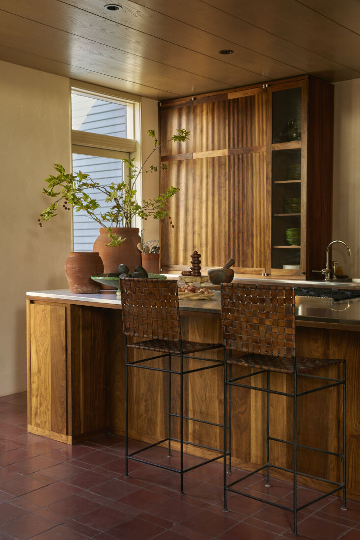 a warm palette in the kitchen thanks to black walnut cabinetry, woven leather s 22