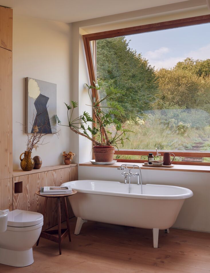 Situated upstairs from the living area, Russell and Oona\2\17;s suite has two giant pivot windows (one that\2\17;s installed in the bathroom) that frame the meadow, woodlands, and fruit orchard.