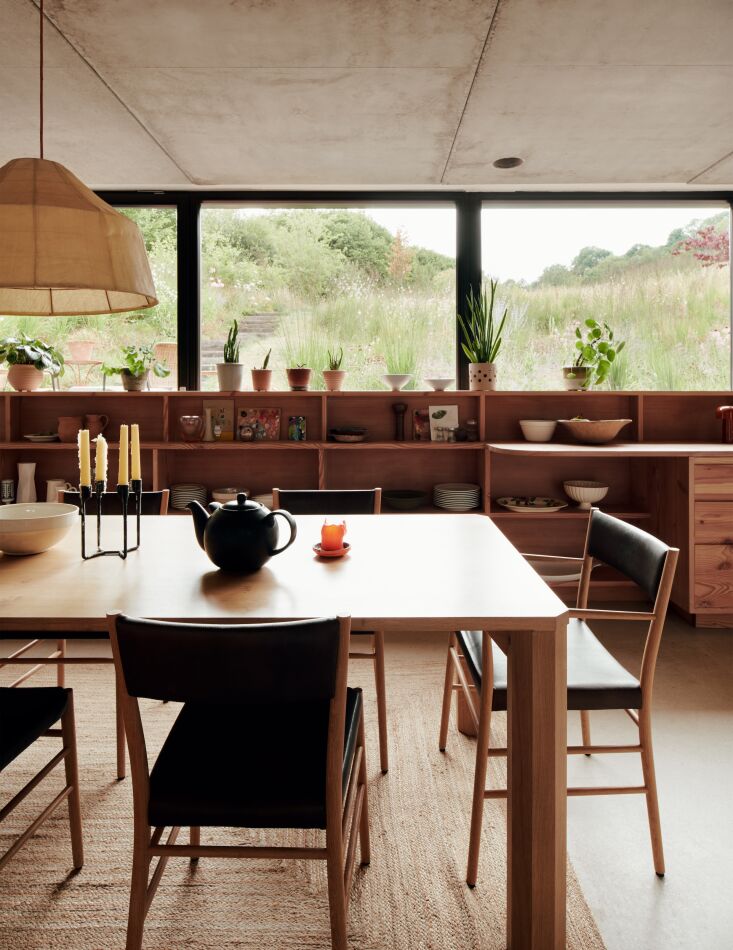 Steps lead down to a sunken dining room and kitchen. \2\20;I was worried the room would have an underground feel\230;but thanks to an \1\1-meter-wide window with no verticals, the opposite is true: we look out at garden and sky,\2\2\1; says Russell. The pendant light is the Soren 600, which has a shade made from plant fiber.