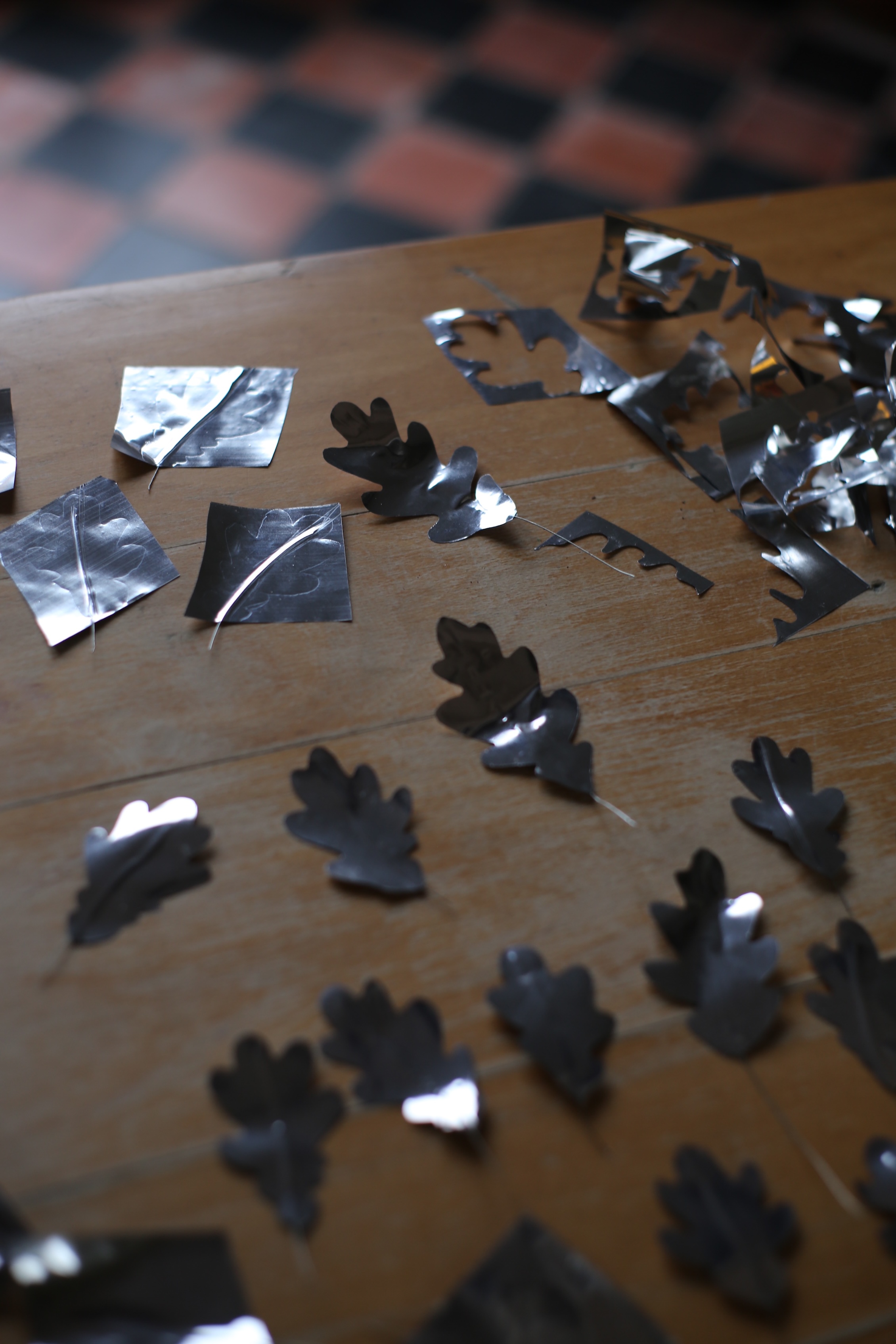 A length of wire is sandwiched between the foil layers with a tail used for twisting the leaves onto a branch.