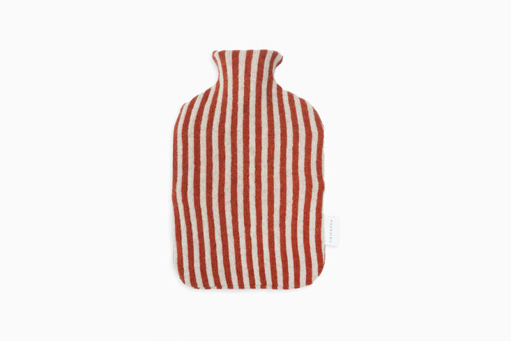 For tucking into bed early: a striped lambswool snug for a hot water bottle. Shop now.