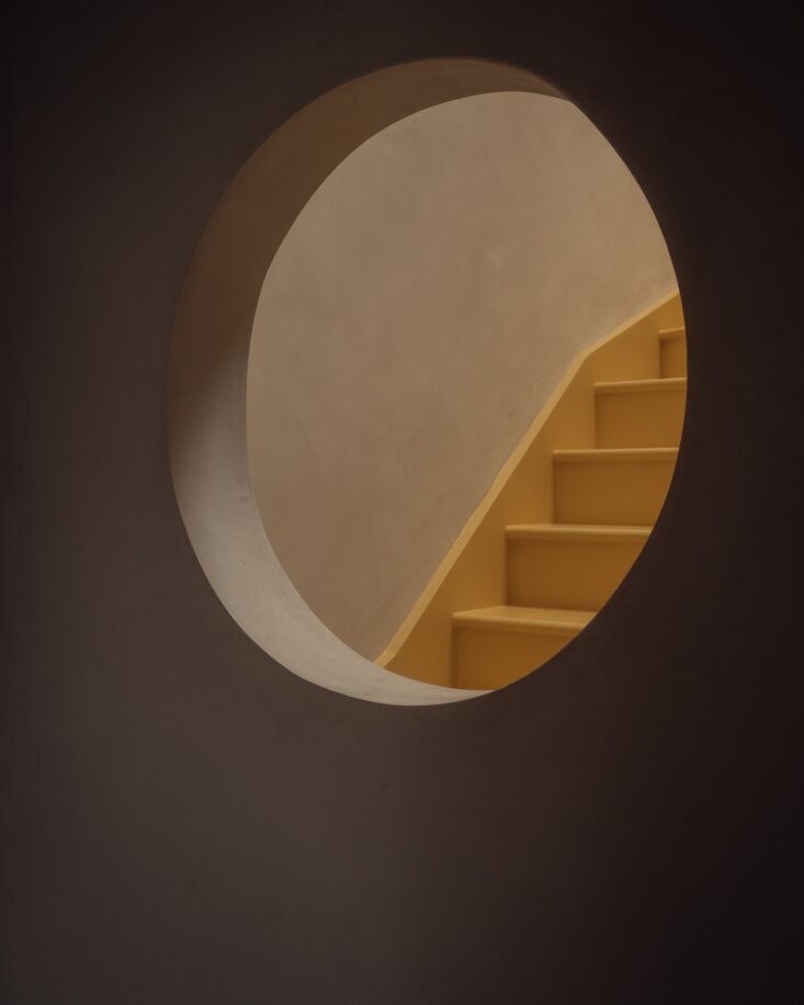   a porthole view of the attic stair. the interior walls throughout are finish 28