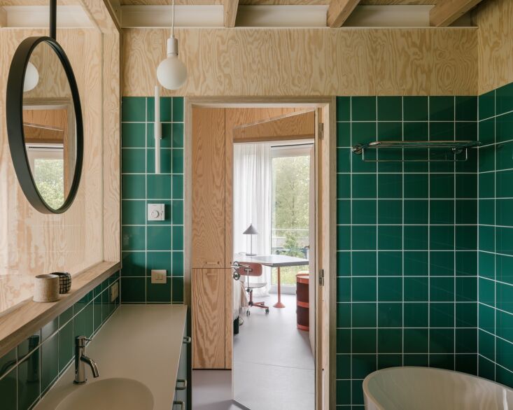 the bathroom has a window overlooking the downstairs living area. it has a vani 26