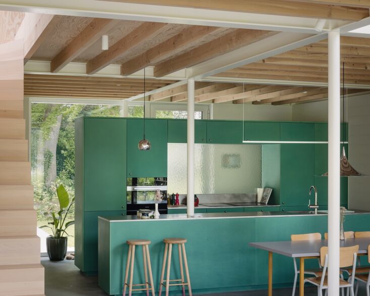 the custom kitchen is finished in valchromat, a sophisticated, sustainable mdf, 22