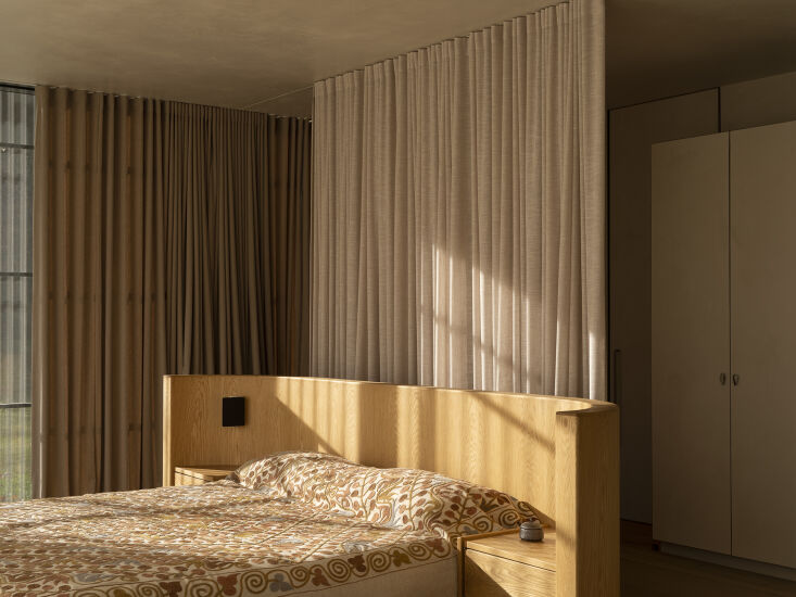 the curved headboard in the main bedroom was designed custom by lockhart and ma 29