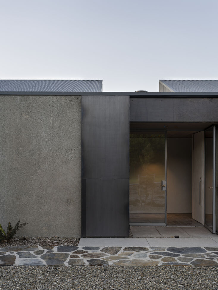  the main entry door is made of steel framed glass with a gate made of raw ste 18