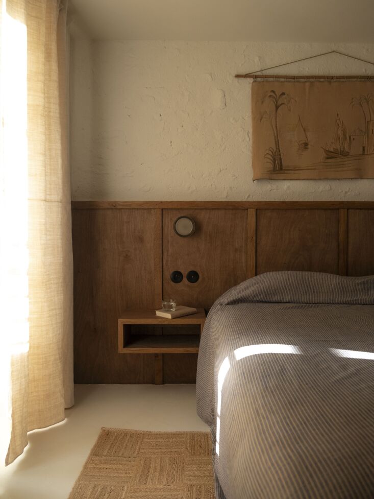 a built in headboard and bedside table, also by charly. the curtains are a mix 20