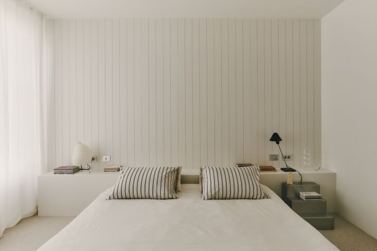 in the bedroom, simplicity reigns. a ledge cum headboard also serves as storage 25
