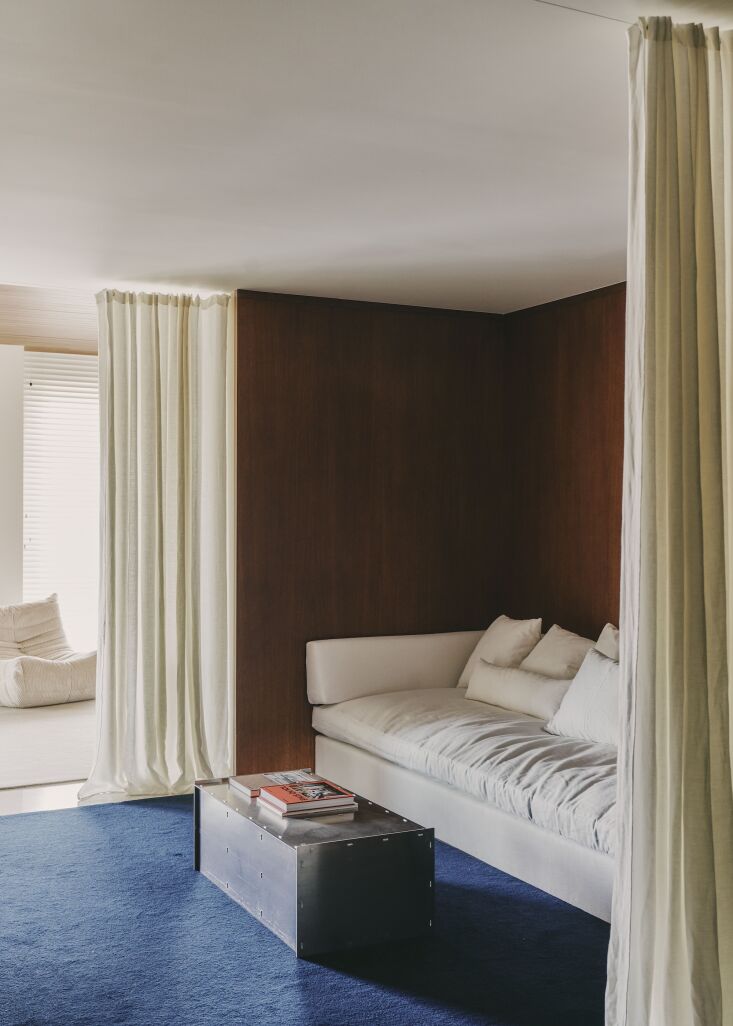 the extra large sofa and blue wool rug are both custom. the aluminum coffee tab 24