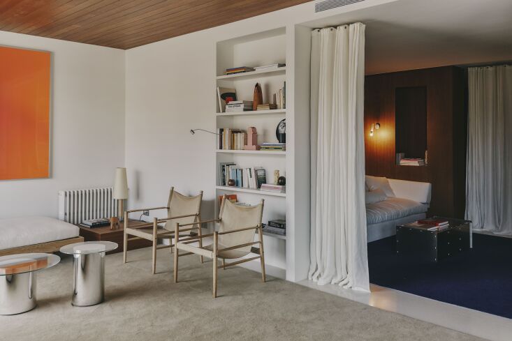 floor to ceiling drapery separates the living room from the tv room. 23