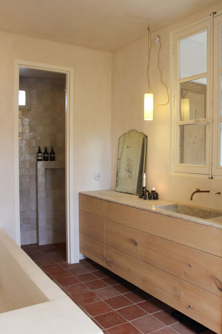 the main bath is designed with chestnut drawers and a quartzite top. the shower 22