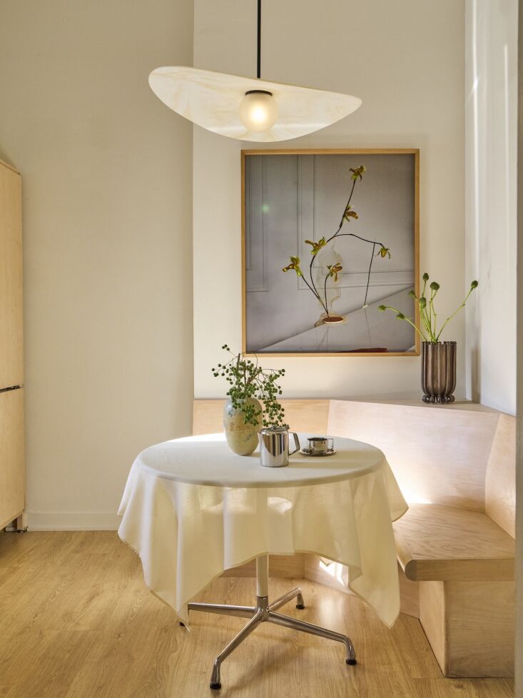 the kitchen came with its banquette. the hanging light is the myrna pendant by  22