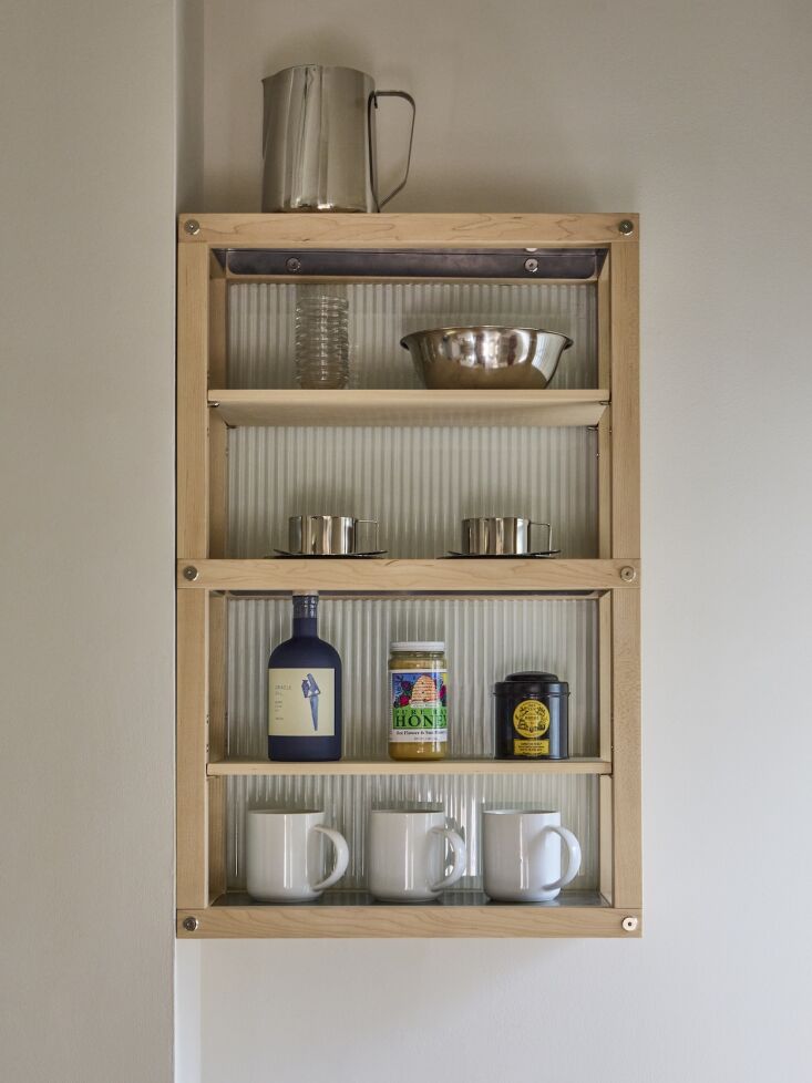 the hanging shelves are red oak with nickel hardware and fluted glass. photogra 23