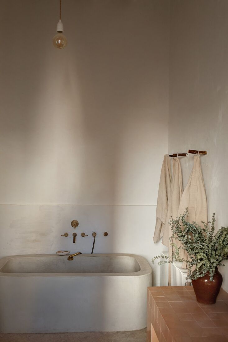 the big enough for two bathtub is microcement and was built onsite by a special 26