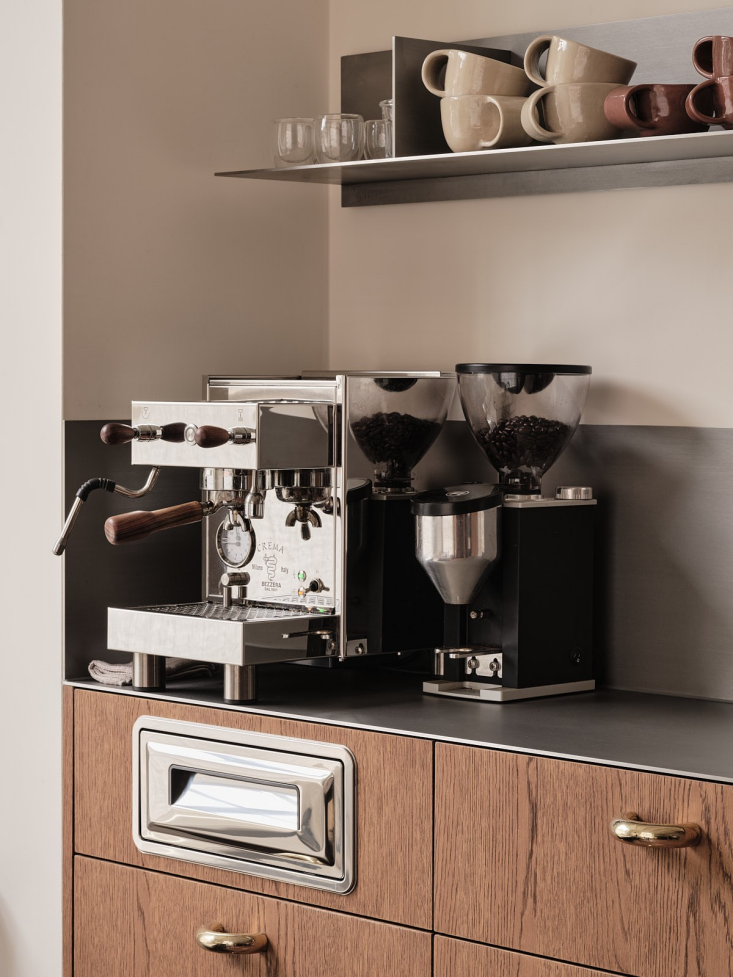 integrated into the cabinet below the coffee area is a stainless steel compost  18