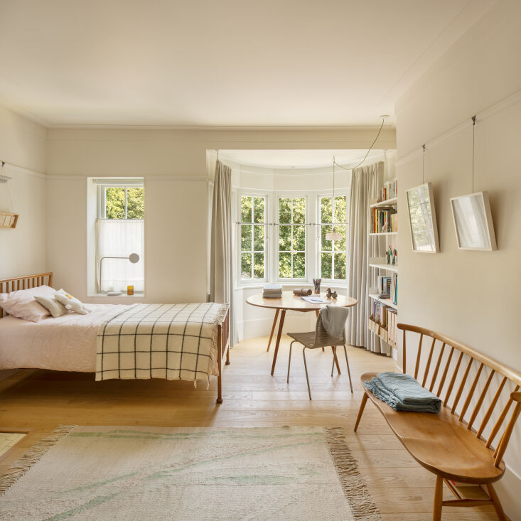 the couple\2\17;s daughter sleeps in a vintage spindle back ercol bed th 40