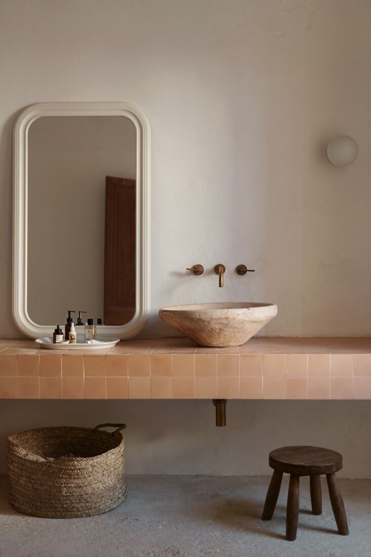 the bathroom counter is finished in hydraulic cement tiles from local maker hug 25