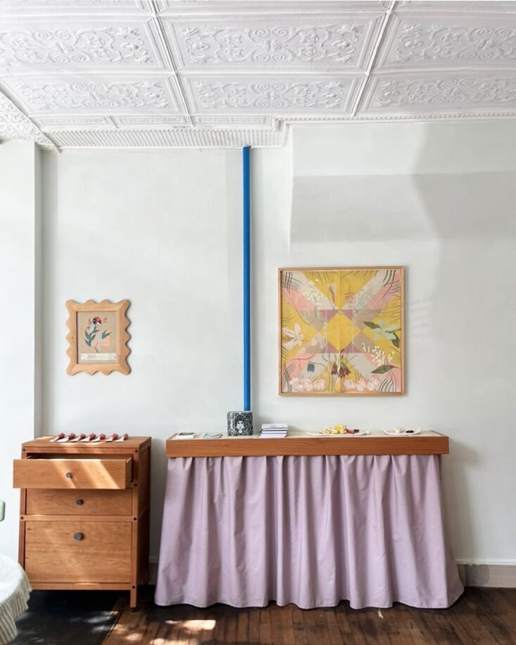 a tiled and skirted fir shelf covers a radiator in the studio—the wood frame  25